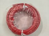 a red wire wrapped in plastic on a white surface