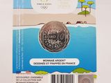 the coin is in a clear holder on a white surface
