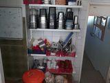 a shelf with pots and pans on it in a kitchen