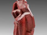 a red sculpture of a woman holding a child