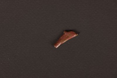 a small piece of chocolate sitting on top of a black surface