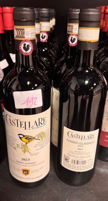 several bottles of wine are lined up on a shelf in a store