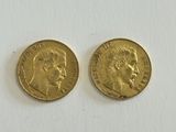 two gold sovereigns, one with the head of a woman and one with a man ' s face