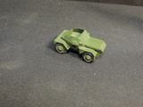 a green toy truck that is sitting on a table