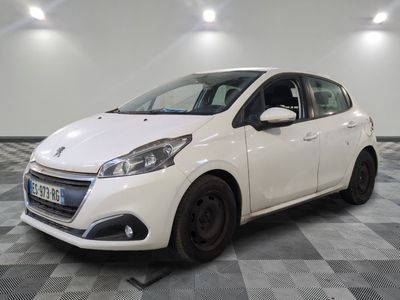 the small white car is parked in the garage on a checkered floor