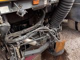 a close up of a truck with a brush on the ground
