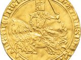 a close up of a gold coin with an image of a man on a horse