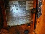 a rusted metal sign on the side of a rusted vehicle