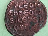an old coin that is on a green surface