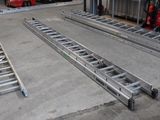 two metal ladders that are sitting in a garage
