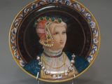 a decorative plate with a picture of a woman on it