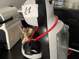 a coffee maker that is on the counter in the kitchen