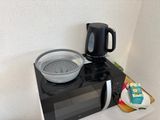 a microwave with a bowl on top of it next to a microwave oven