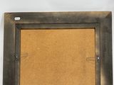 a close up of a picture frame on a white wall