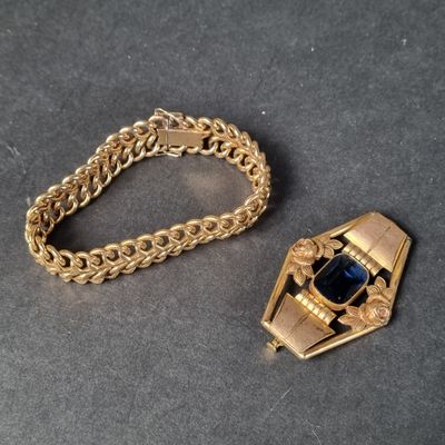 two pieces of jewelry that are on a table