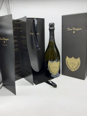une bouteille de champagne posée à côté d'une boîte noire