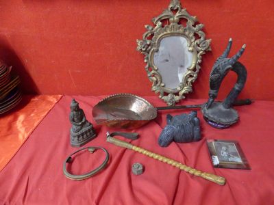 a table with a mirror, a mirror, a bowl, a spoon, and other items on it