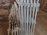 a large pile of metal pipes in a building