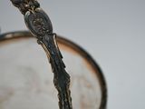 a silver spoon sticking out of a glass of water