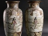 pair of asian vases on a black background with a woman on a horse