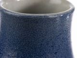 a blue vase that is sitting on a table