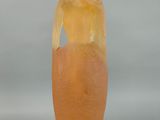 a glass vase with a piece of fruit inside of it
