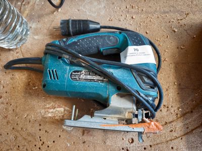 a corded nailer and a stapler on the floor