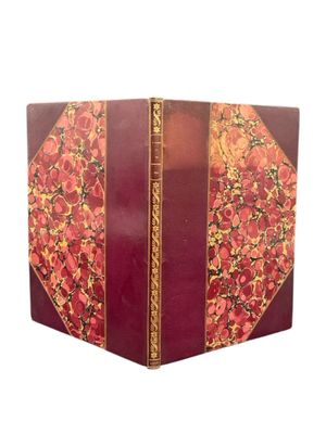 an image of a red book with gold trim and a floral design