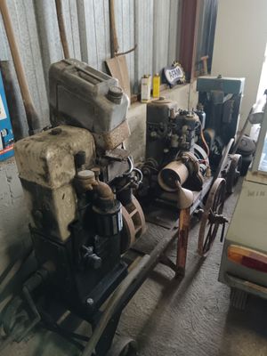 a small engine sitting on a cart in a garage