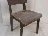 a wooden chair that is sitting on a white floor