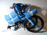 a blue bike with a blue bag strapped to it