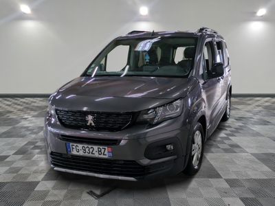 the grey van is parked in a large room with a checkered floor