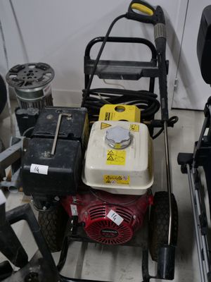 two lawn mowers sitting next to each other on the floor