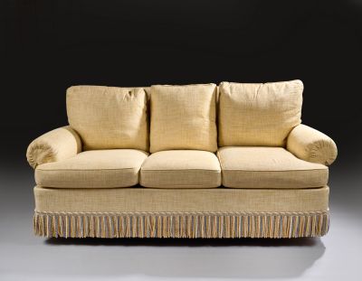 an image of a beige couch with two pillows on top of it