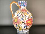 a vase with a floral design on it sitting on a table