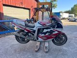 a picture of a red and white motorcycle parked in front of a building
