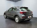 the rear end of a grey volkswagen suv parked in a showroom