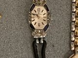two watches are sitting next to each other on a table