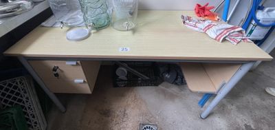 a wooden desk with a glass vase on it