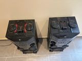 two speakers sitting next to each other on the floor