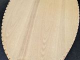 an image of a wooden cutting board sitting on a black surface