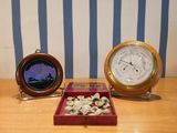 two clocks sitting on a table next to each other