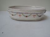 a white bowl with a design on it on a table