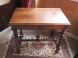 a small wooden table with a drawer on top of it