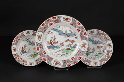 three chinese plates with flowers and birds on them on a black background