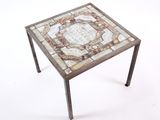 an image of a small table with a mosaic top and metal legs