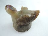 a picture of a bird figurine on a white surface