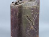 an old purple metal canister with a metal handle on a white background