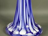 a blue and white vase sitting on a table