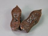 two pieces of wood carved into the shape of a shoe